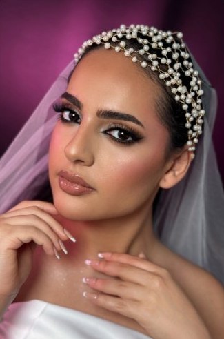 Bride with pearl headpiece and veil, bridal makeup in Dubai by Caroline